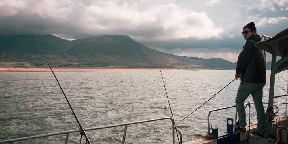 Man fishing off of boat