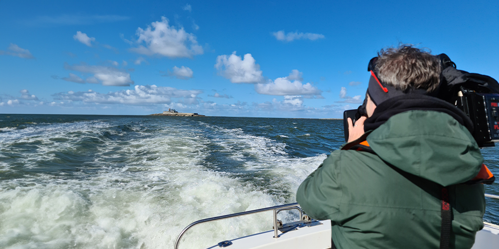 man holding camera on boat